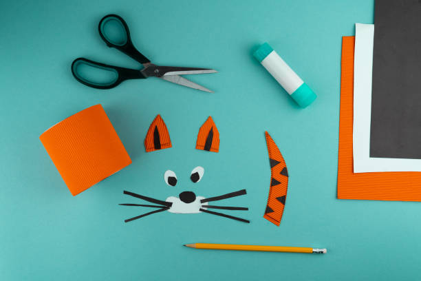 istock Step 5. Step-by-step instructions on how to make a stand for stationery from a tin can. Tiger made of paper and cardboard, scissors and glue. A fun DIY craft for children. Do it yourself paper tiger 1298858578