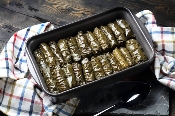 istock Traditional Oriental dolmades - stuffed grape leaves baked in ceramic form 1298858610
