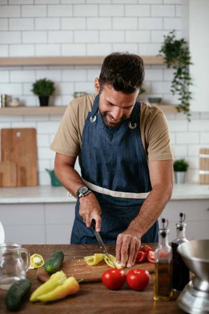 istock Young man preparing delicious food. 1298859144