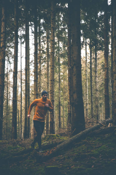 istock Trail runner with smart watch and orange fleece jacket 1298859266