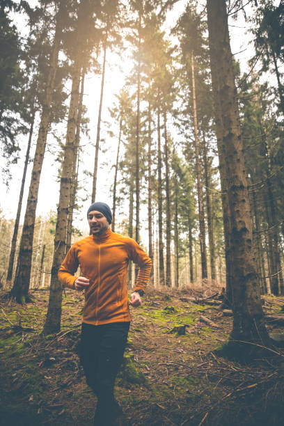 istock Trail runner with smart watch and orange fleece jacket 1298859267