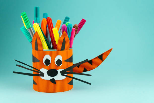 istock Step 9. Step-by-step instructions on how to make a stand for stationery from a tin can. Tiger made of paper and cardboard, scissors and glue. A fun DIY craft for children. Do it yourself paper tiger 1298859273