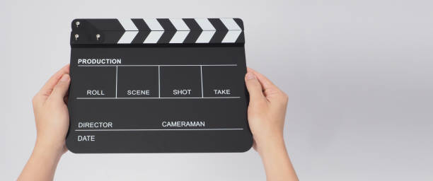 istock Hands is holding black Clapper board or Clapperboard or movie slate. it use in video production ,film, cinema industry on white background. 1298861961