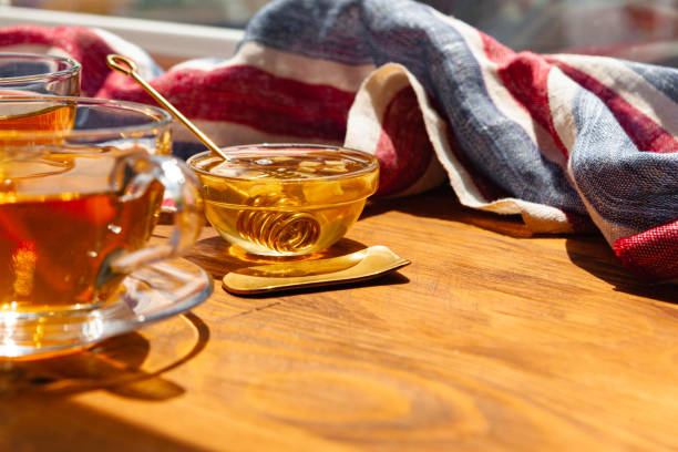 istock Close up of glass tea cup with honey 1298863670