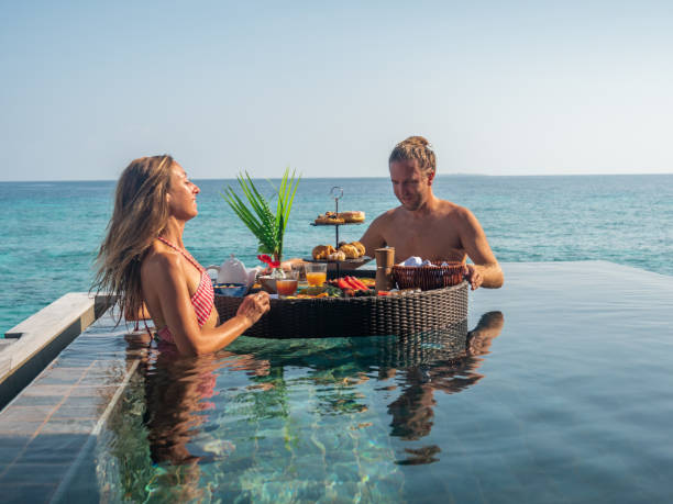 istock Couple enjoying floating breakfast in luxury hotel 1298863687