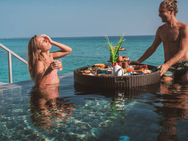 istock Couple enjoying floating breakfast in luxury hotel 1298863784