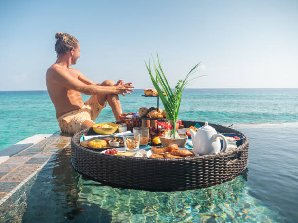 istock Man enjoying floating breakfast in luxury hotel 1298863964