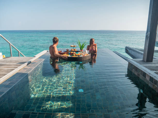 istock Couple enjoying floating breakfast in luxury hotel 1298864416