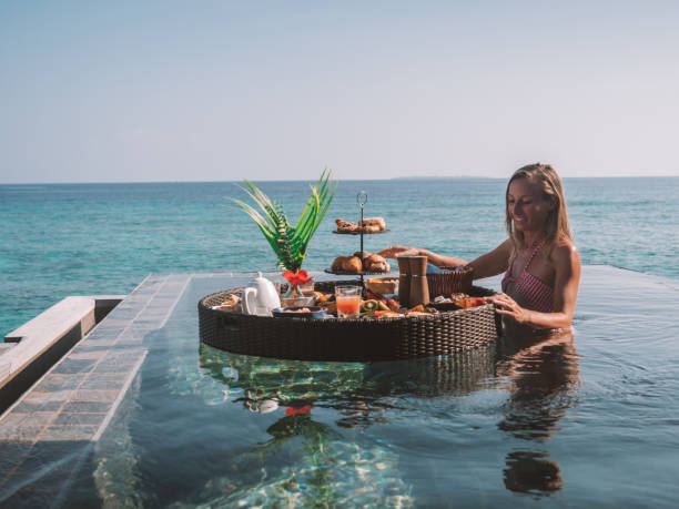 istock Woman enjoying floating breakfast in luxury hotel 1298864498