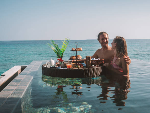 istock Couple enjoying floating breakfast in luxury hotel 1298864729