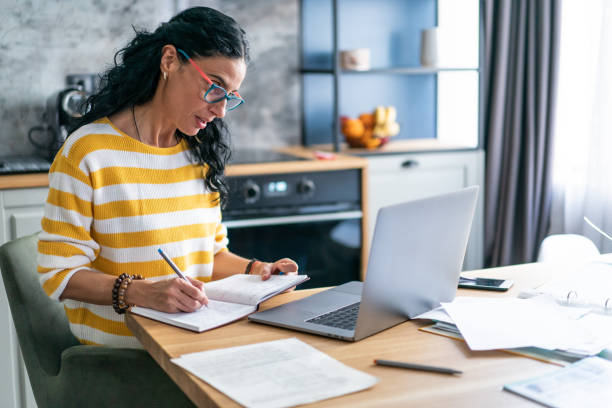 istock Middle aged woman having a video call 1298865774