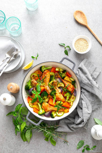 istock Chicken legs baked with vegetables. Top view 1298866591
