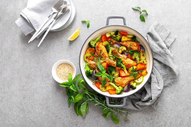 istock Chicken legs baked with vegetables. Top view 1298866827