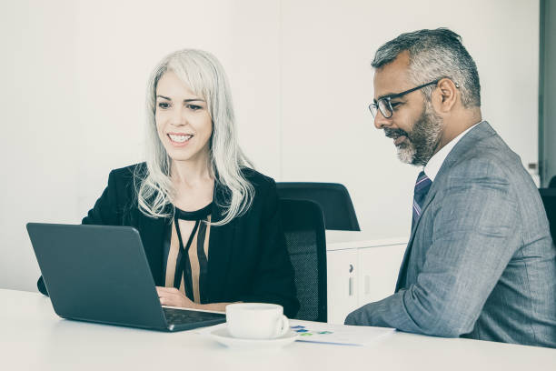 istock Two happy colleagues using laptop for video call 1298867172