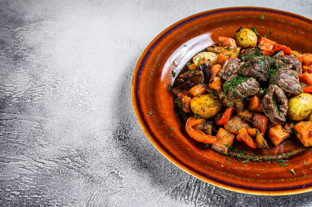 istock Meat stew, goulash on a plate. White background. Top view. Copy space 1298867463