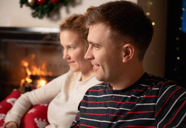 istock Christmas Couple at home by the fireplace 1298867772