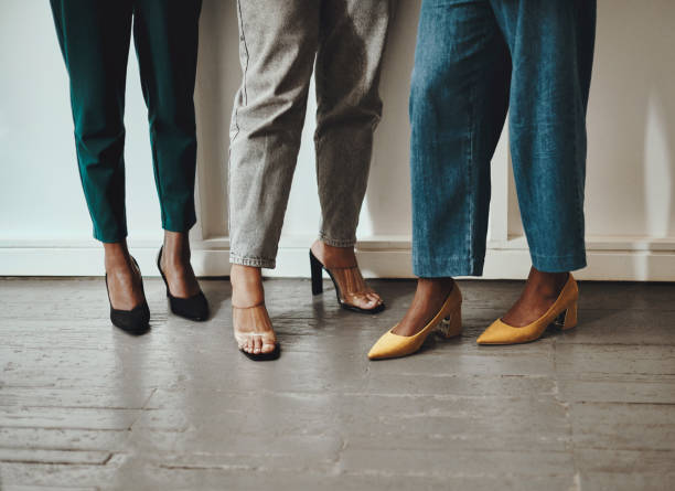 Success that's higher than our heels Shot of a group of unrecognisable businesswomen standing together in a modern office high heels stock pictures, royalty-free photos & images
