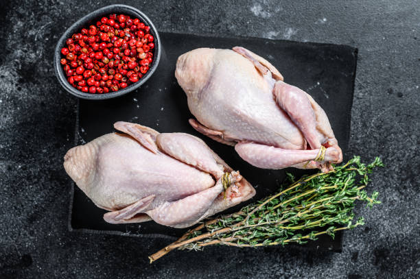 istock Farm eco friendly raw quails ready for cooking. Black background. Top view 1298868508