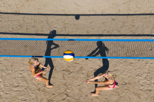 teens volleyball player in action - beach volleying ball playing imagens e fotografias de stock