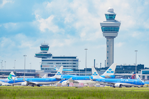 KLM (Koninklijke Luchtvaart Maatschappij - Royal Dutch Airlines) airplanes parked on the tarmac of Schiphol Airport near Amsterdam