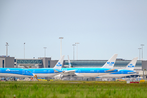 KLM (Koninklijke Luchtvaart Maatschappij - Royal Dutch Airlines) airplanes parked on the tarmac of Schiphol Airport near Amsterdam