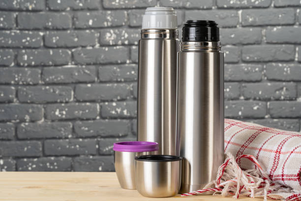 istock Aluminum metal thermos container bottle close up on table 1298870904