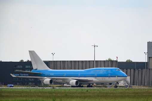 Decommissioned KLM (Koninklijke Luchtvaart Maatschappij - Royal Dutch Airlines) Boeing 747 jumbo jet airplane parked on the tarmac of Schiphol Airport. The KLM brand name and logo has been removed from the airplane fuselage and tail.