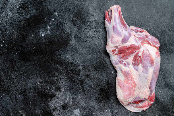 istock Raw lamb shoulder meat. Black background. Top view. Copy space 1298871438