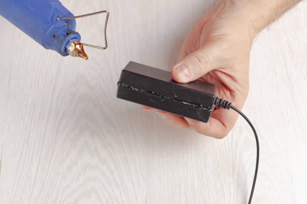 istock Repairing the laptop's power supply 1298871442