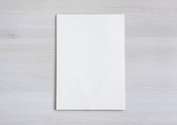 istock Stack of paper folios on wooden desk. high view 1298873321