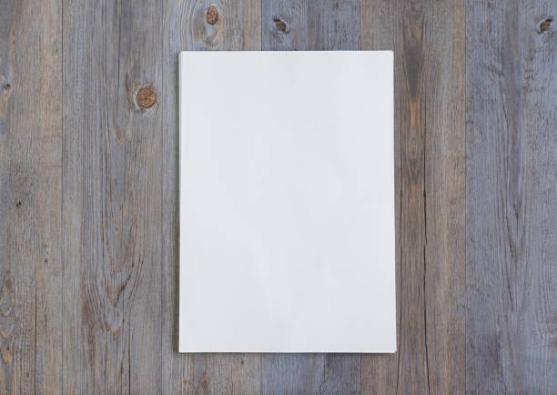 istock Stack of paper folios on wooden background. high view 1298873334
