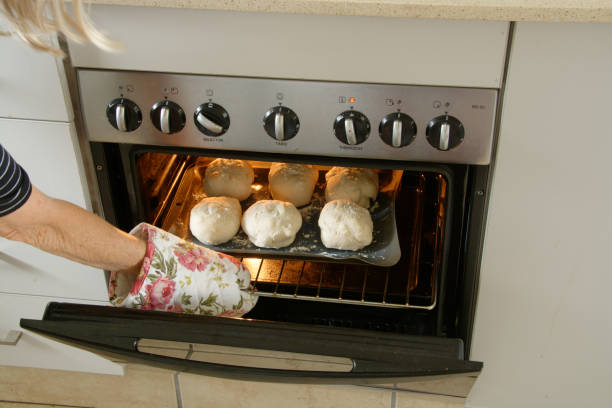 istock Bread rolls being placed in the oven to be cooked 1298874217