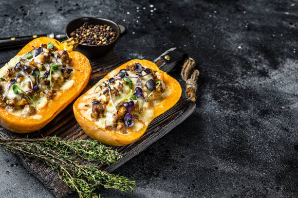istock Pumpkin stuffed with mince beef meat, vegetables and herbs Black background. Top view. Copy space 1298876187