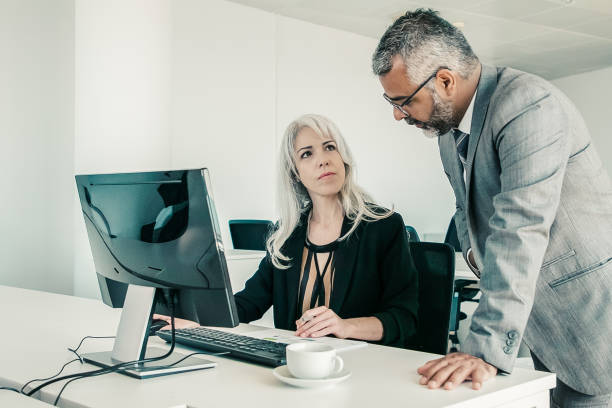 istock Serious male and female colleagues 1298877432