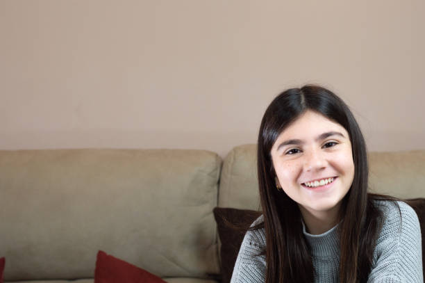 istock girl on the sofa watching tv with the remote control in hand 1298877939