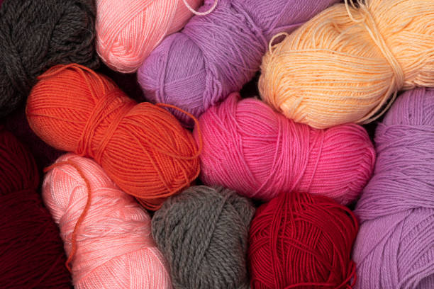 istock Background from multi-colored balls of yarn for knitting spread out chaotically. Flatley. Filmed from above. 1298879057