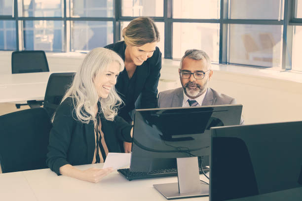 istock Cheerful business group watching presentation and laughing 1298880587