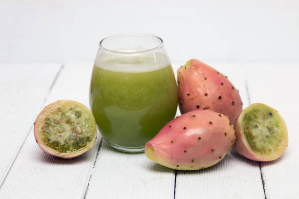 Juice made from opuntia ficus-indica cactus fruits on a white background View of drinkable juice made from opuntia ficus-indica cactus fruits on a white background nopal fruit stock pictures, royalty-free photos & images