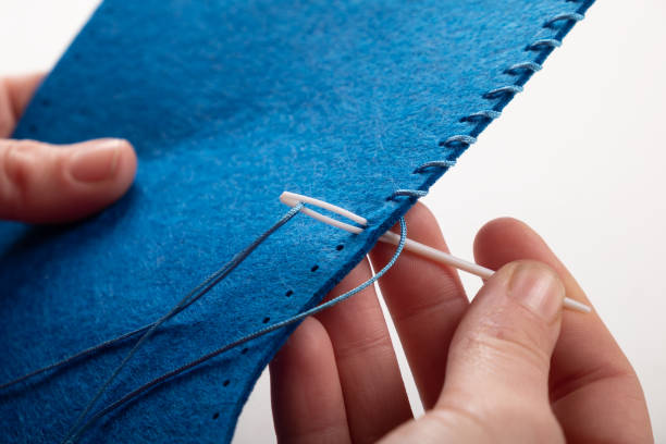 sew by hand, stitch craft fabric close up.