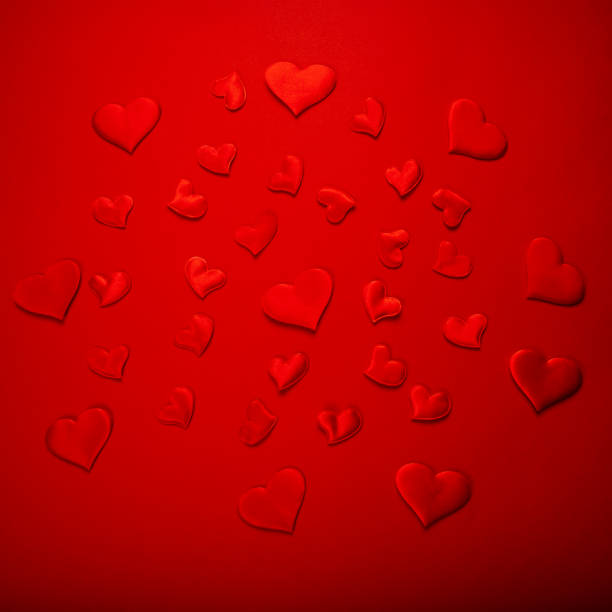 istock Red hearts on color background 1298883928
