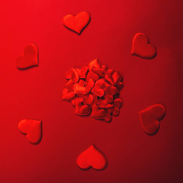 istock Red hearts on color background 1298883934