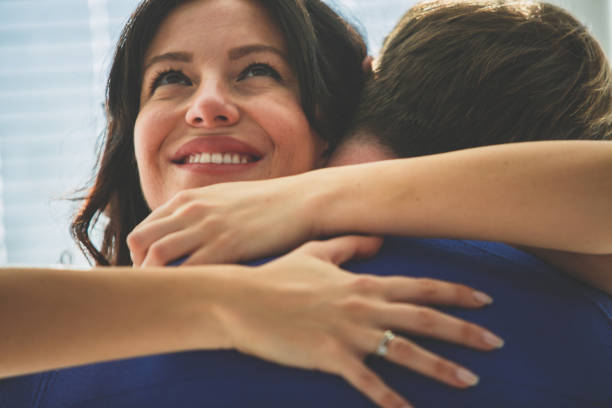 istock Joyful woman enjoying a romantic hug with her husband 1298883990