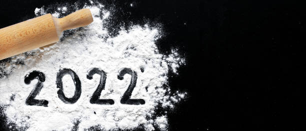 istock Baking flour and number 2022 on black board 1298885652