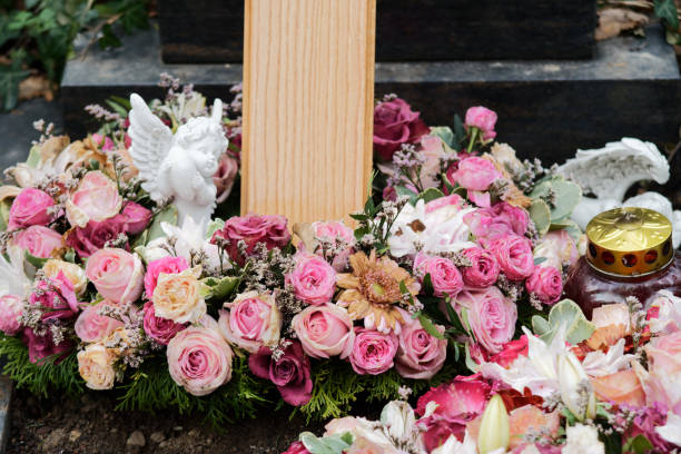 funeral wreath with roses funeral wreath with roses and an angel on a grave after a funeral pink memorial candle with flowers stock pictures, royalty-free photos & images