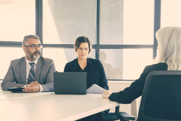 istock Serious company managers talking to job candidate 1298888335