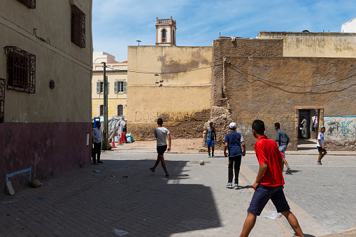 El Jadida, Morocco - April 16, 2016: Street scene in the city of El Jadida, with young boys playing soccer (football) in a square on the old Portuguese City.