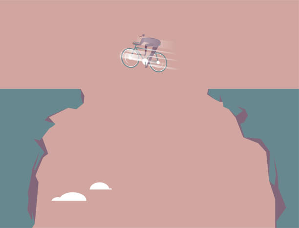 istock Businessman leaps over the canyon on a bicycle. 1298890745