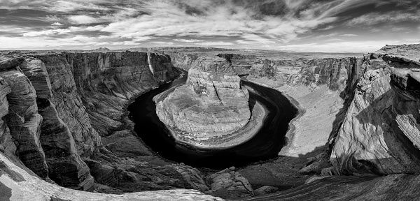 Black and white aerial view over Horseshoe Bend, an eroded canyon of the Colorado river in the form of a horseshoe.