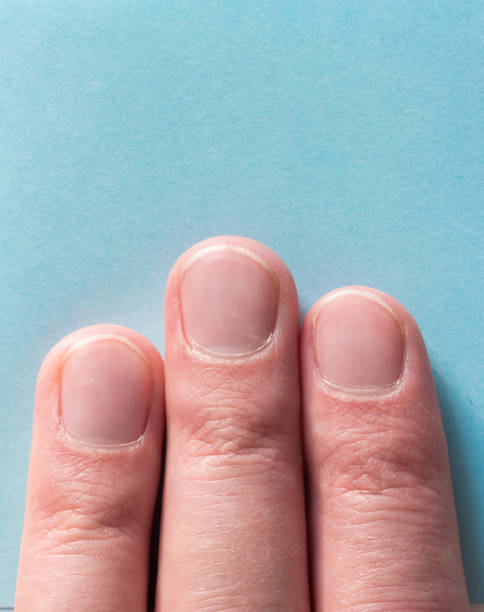 istock Three male fingers on blue background top view macro shot 1298892798