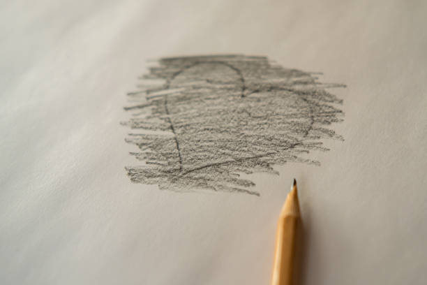 istock Heart drawn in black pencil on paper. 1298893357